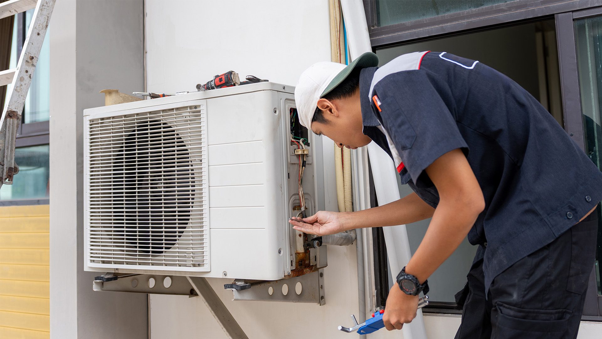 HVAC technician servicing an outdoor unit